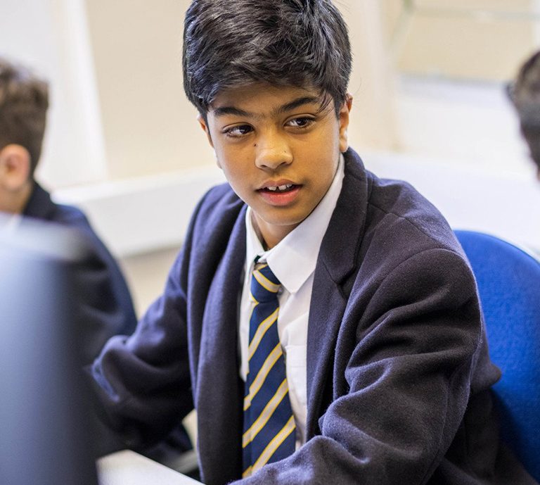 3 students in the computer room working