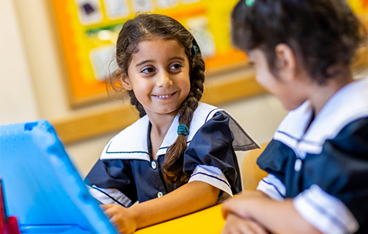 student in the classroom working with a smart tablet