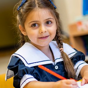 young student writing onto paper