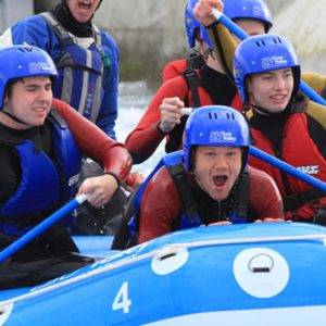 group of students in a white water raft