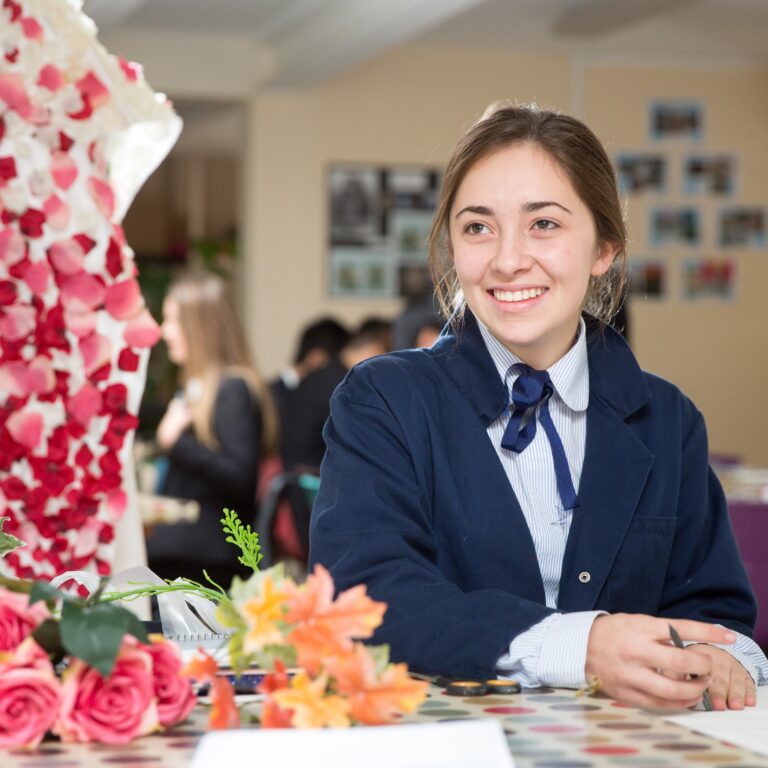 girl smiling at her art work