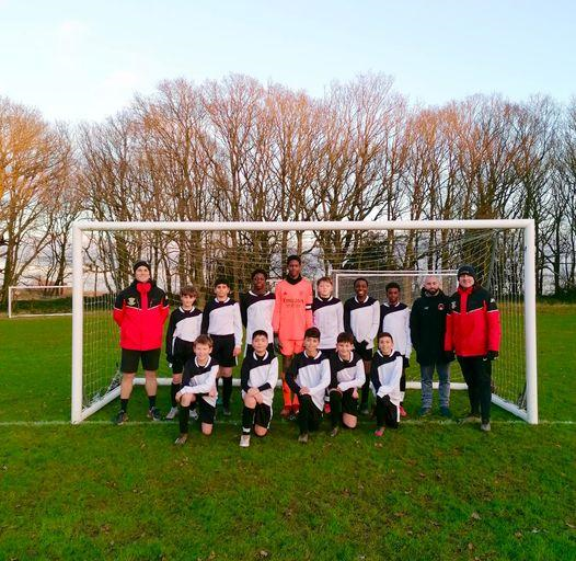 Students in the football group by the goals