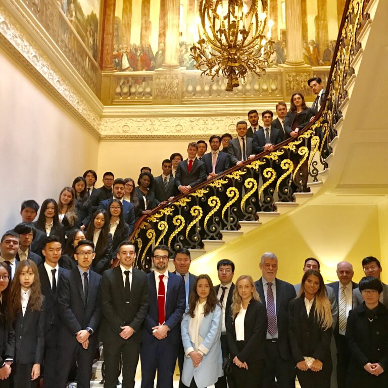a large group of students and teachers along a grand staircase
