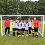 group of school boys wearing medals and football kits