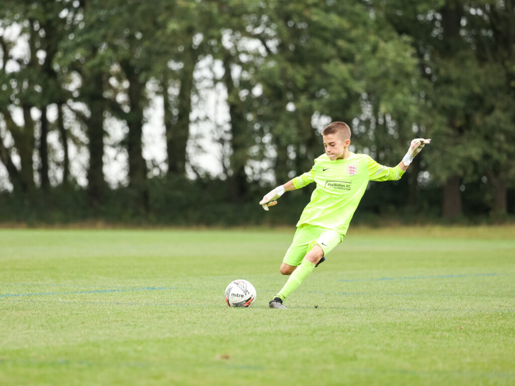 boy kicking a ball