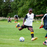 boy kicking a ball
