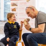 student touching a bone