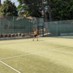 student playing tennis