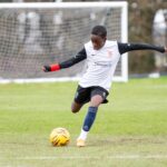 student playing football