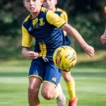 student playing football