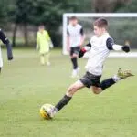 boy kicking a ball